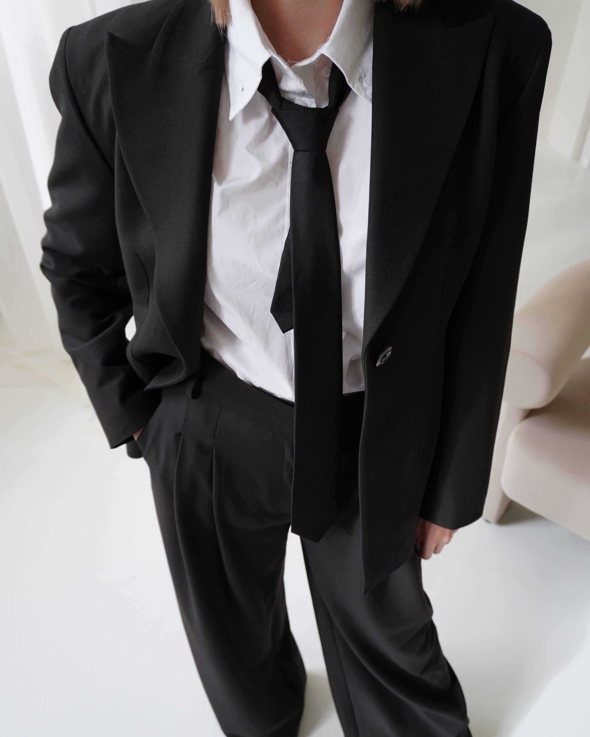 Detail of high-waist tailored Dione trousers styled with Hourglass Blazer.