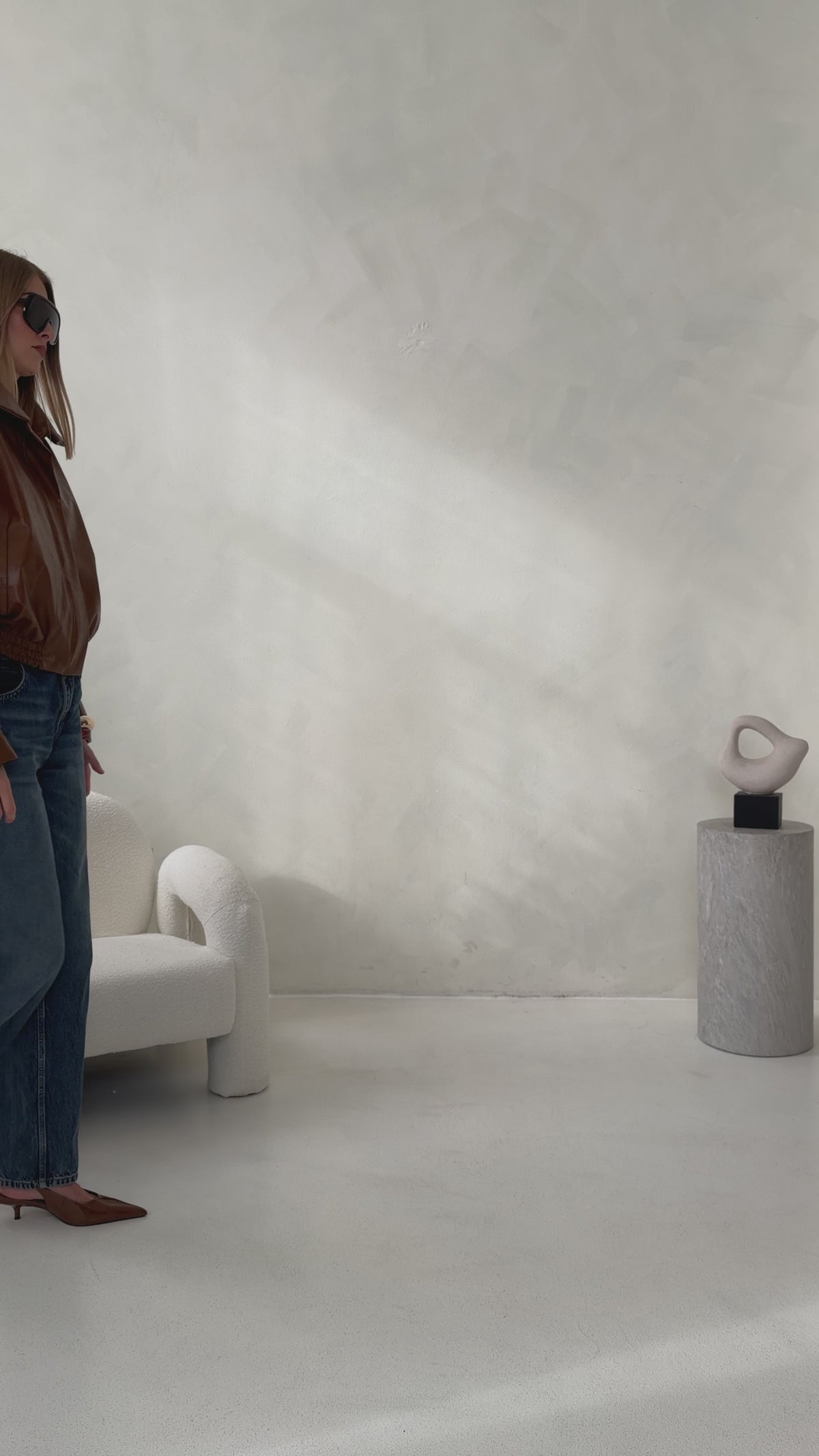 Video showcasing the brown HERA Faux Leather Jacket by THÉFI, highlighting its oversized silhouette, structured shoulders, statement funnel neck and gathered hem.