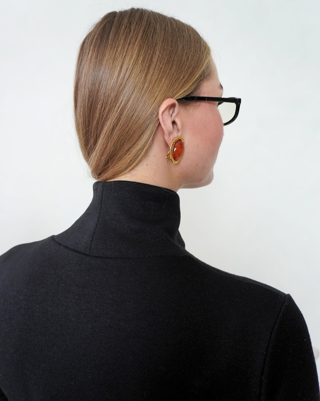 Close-up back view of the black SELENE Turtleneck, showing the shape and height of its structured stand collar.