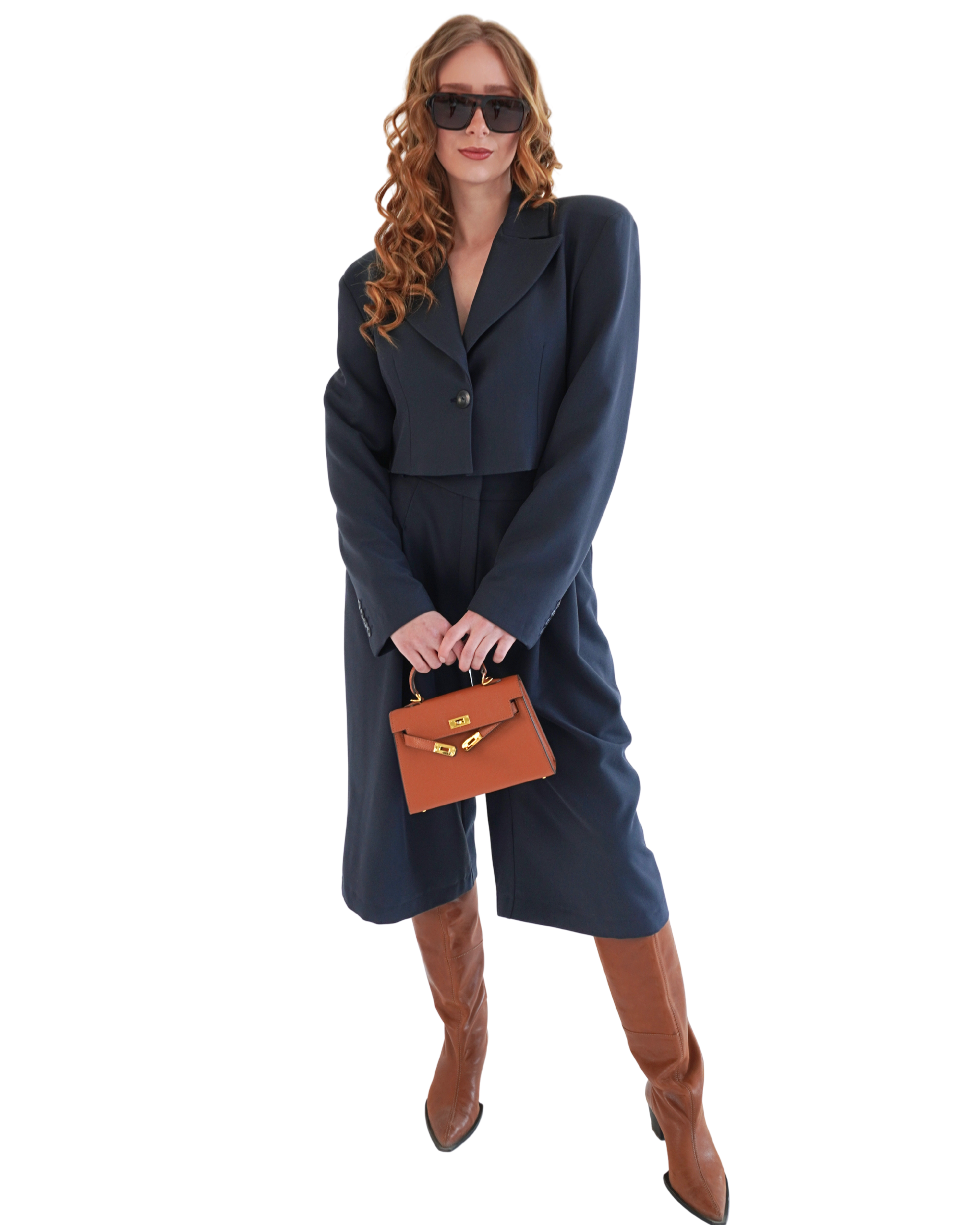 Navy crop blazer THÉFI styled with bermuda shorts and a handbag for an elevated full outfit