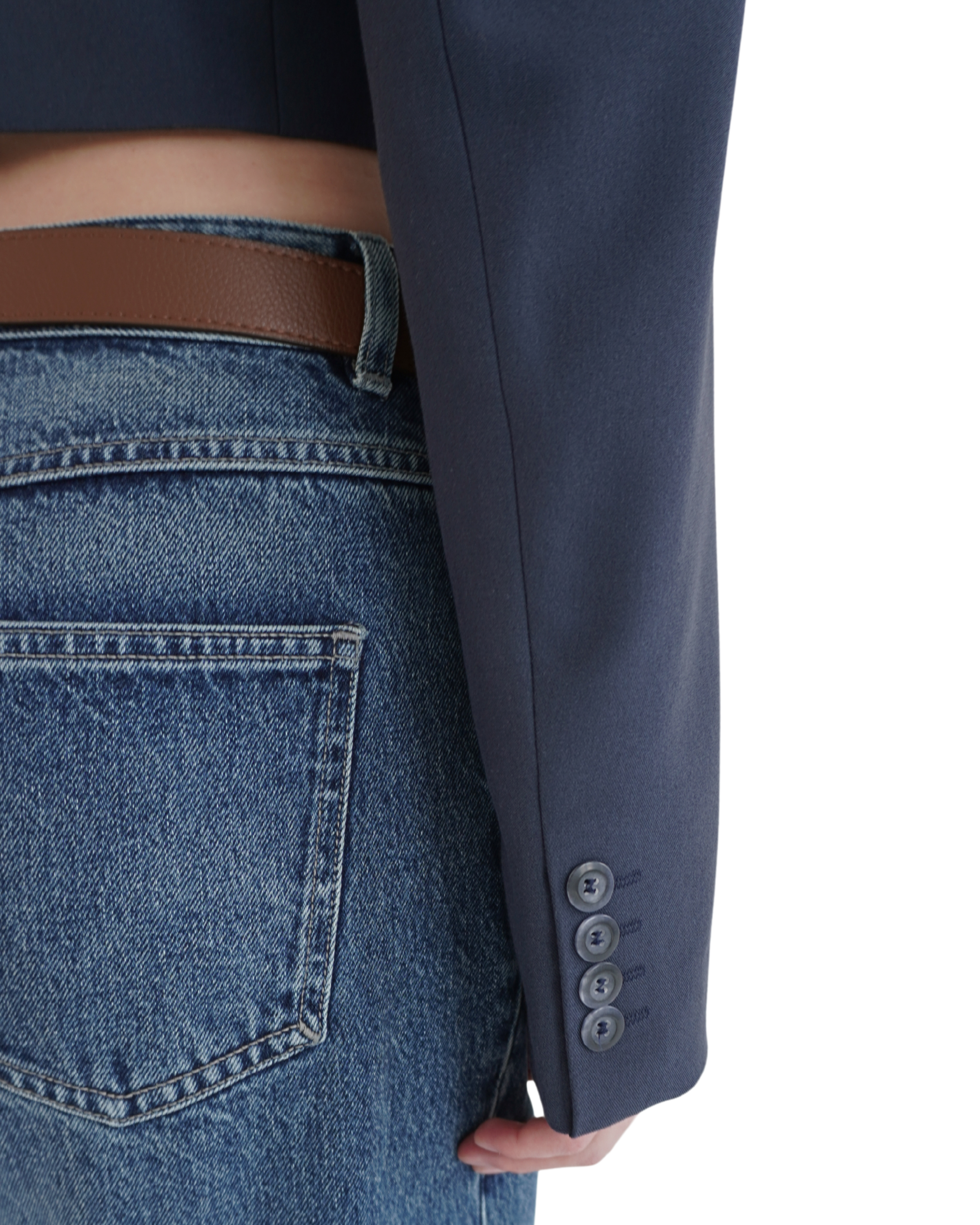 Sleeve detail of navy crop blazer THÉFI styled with denim for a modern contrast